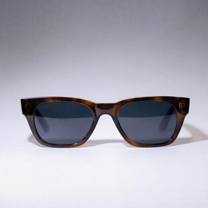A pair of square Bobotails leopard sunglasses with a dark brown tortoiseshell frame and dark gray lenses, photographed against a neutral gray studio background.