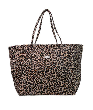 A leopard print tote bag with two shoulder straps, featuring a pattern of black and brown spots on a tan background, with a small silver brand plaque on the front.