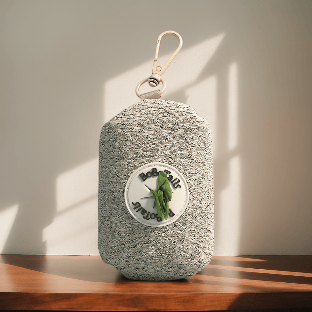 Taupe small pouch with a Bobotails logo on a wooden surface