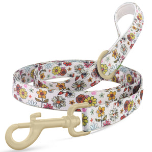 Close-up of a hands-free dog leash with vibrant floral pattern, sturdy clip, and stretchy bungee cord