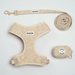 A beige and cream floral patterned pet gear set including a harness, leash, and a matching rolled storage pouch, all branded with 'Bobotails' on a white background.