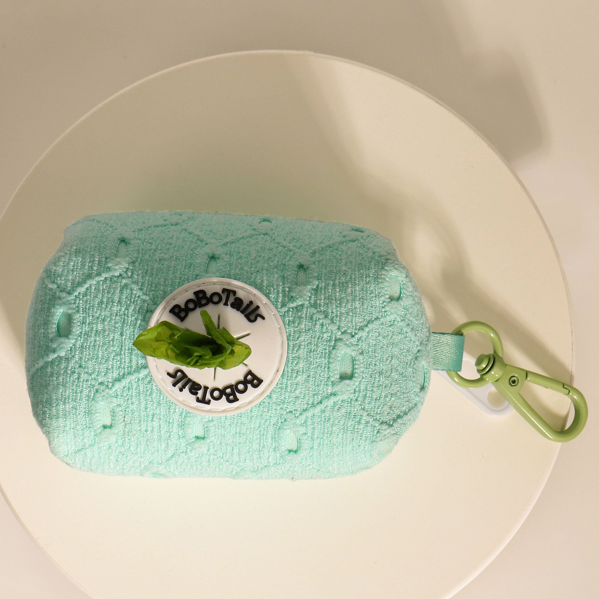 Green textured product with a brand label on a beige plate