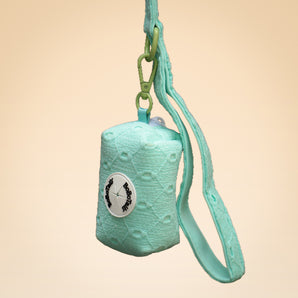 Turquoise textured pouch with a strap on a beige background