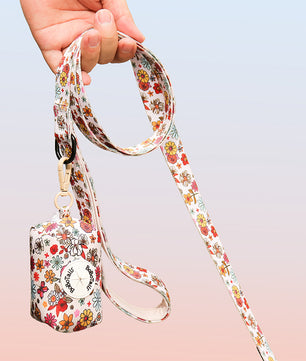 flower printed pet waste bag dispenser matching the harness and owner accessories for daily dog walks