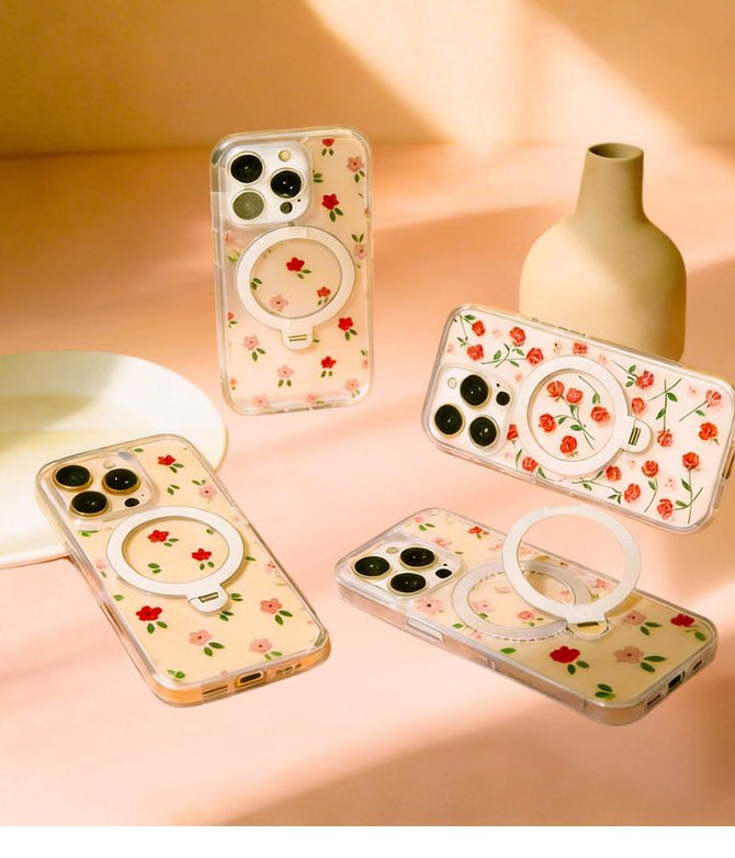 Four floral matching dog harness phone cases with ring stands on a peach-colored surface.